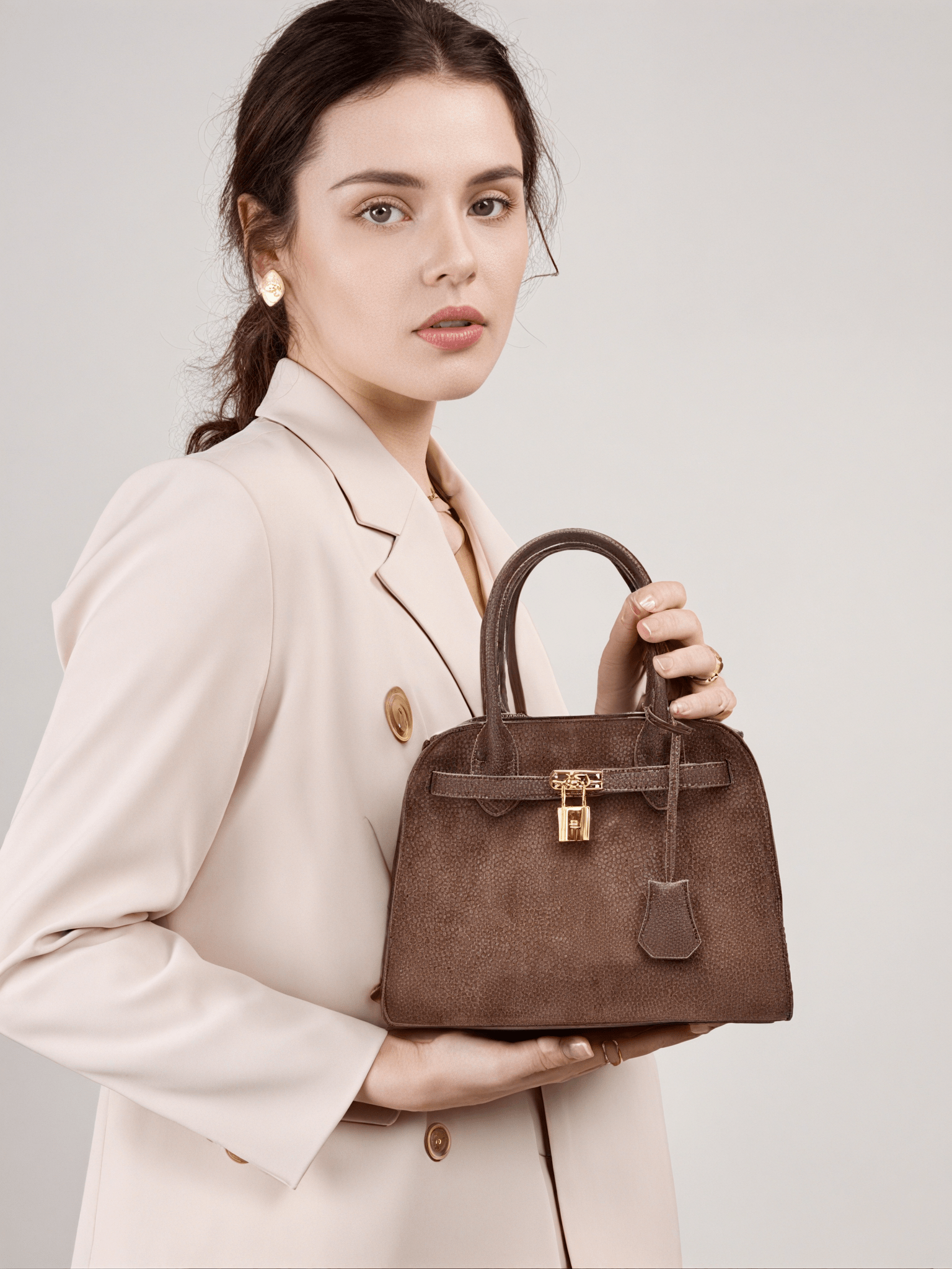 Ramona Top Handle Crossbody Bag in DarkBrown Vegan Leather - Model Holding Front View