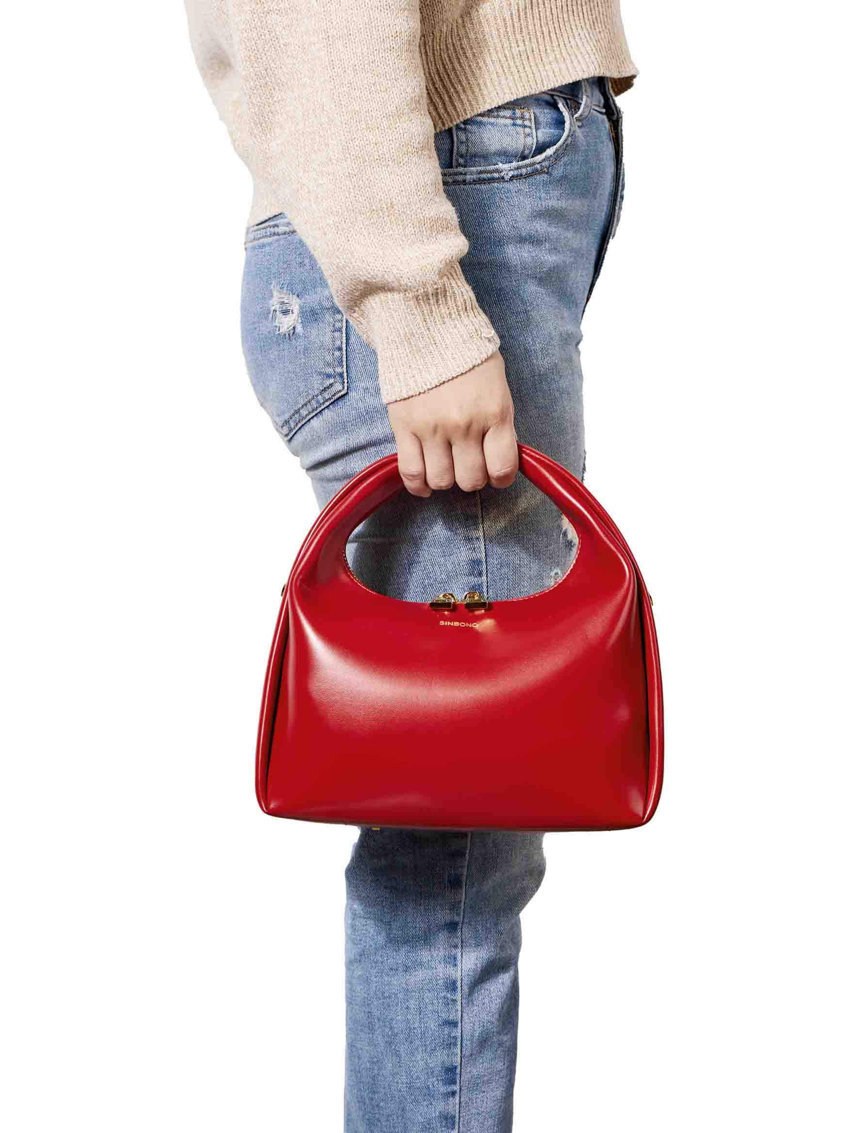 Medium Vienna Top Handle Crossbody Bag in Red Vegan Leather - Model Holding Front View