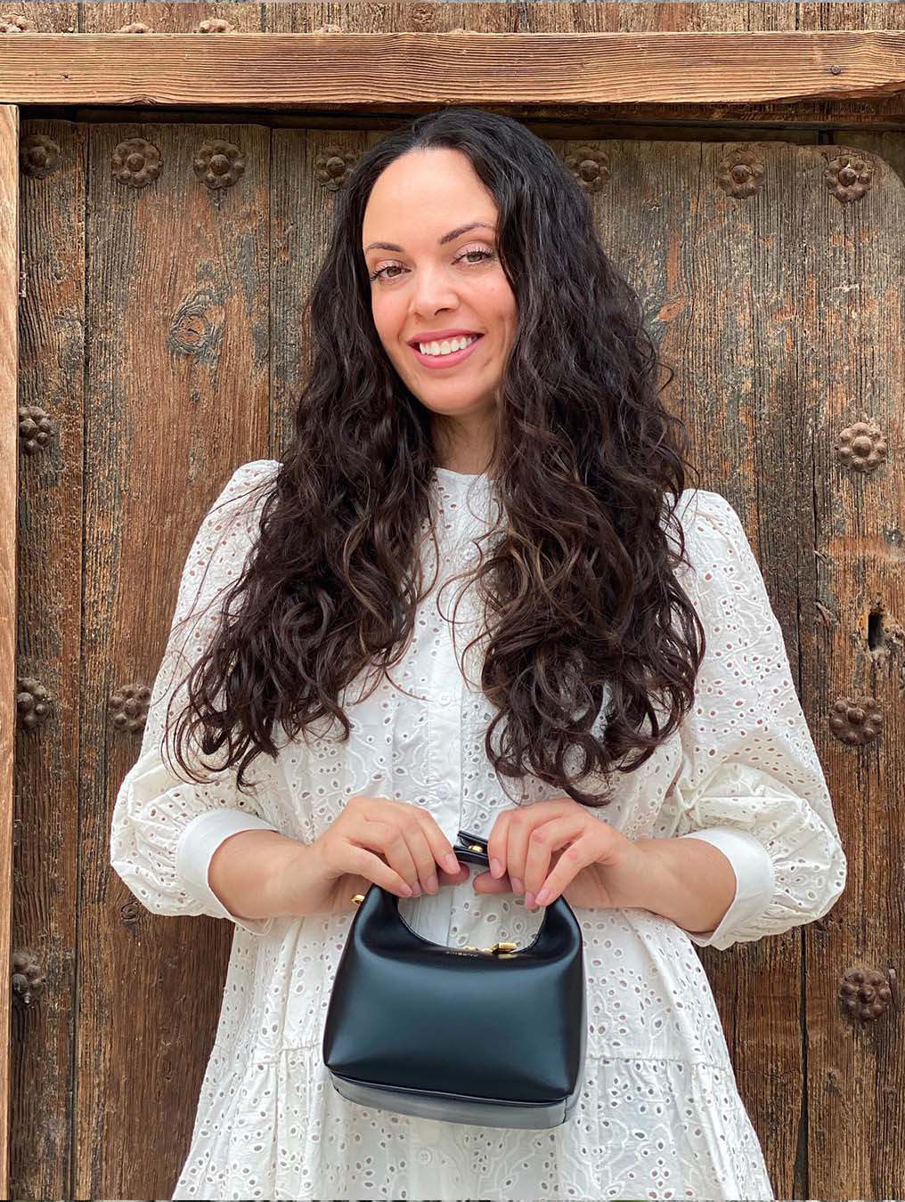 Vienna in Black Vegan Leather - Model Holding Front View