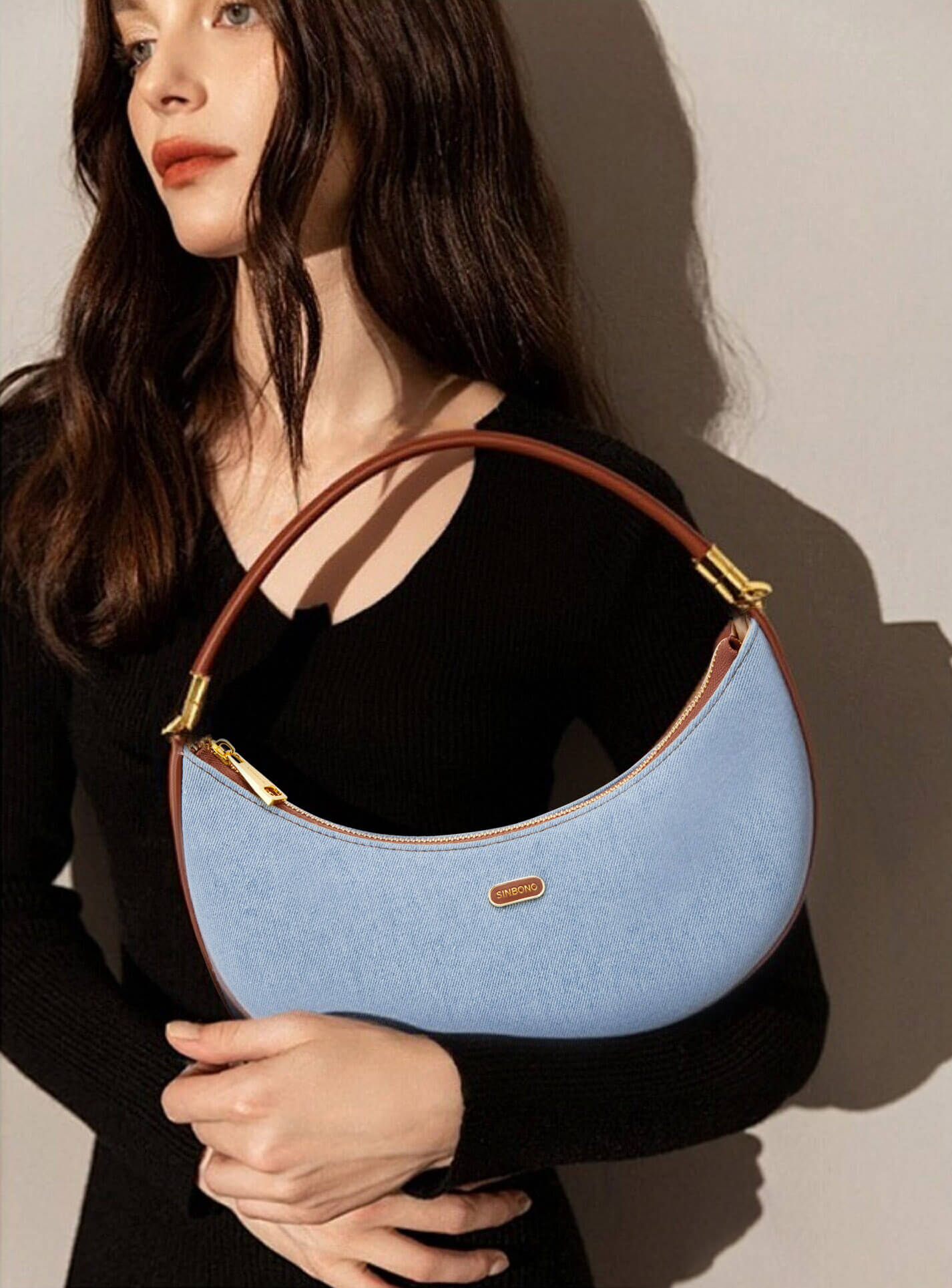 Zoey Shoulder Crossbody Bag in Light blue&Brown Denim texture Leather - Model Holding Front View