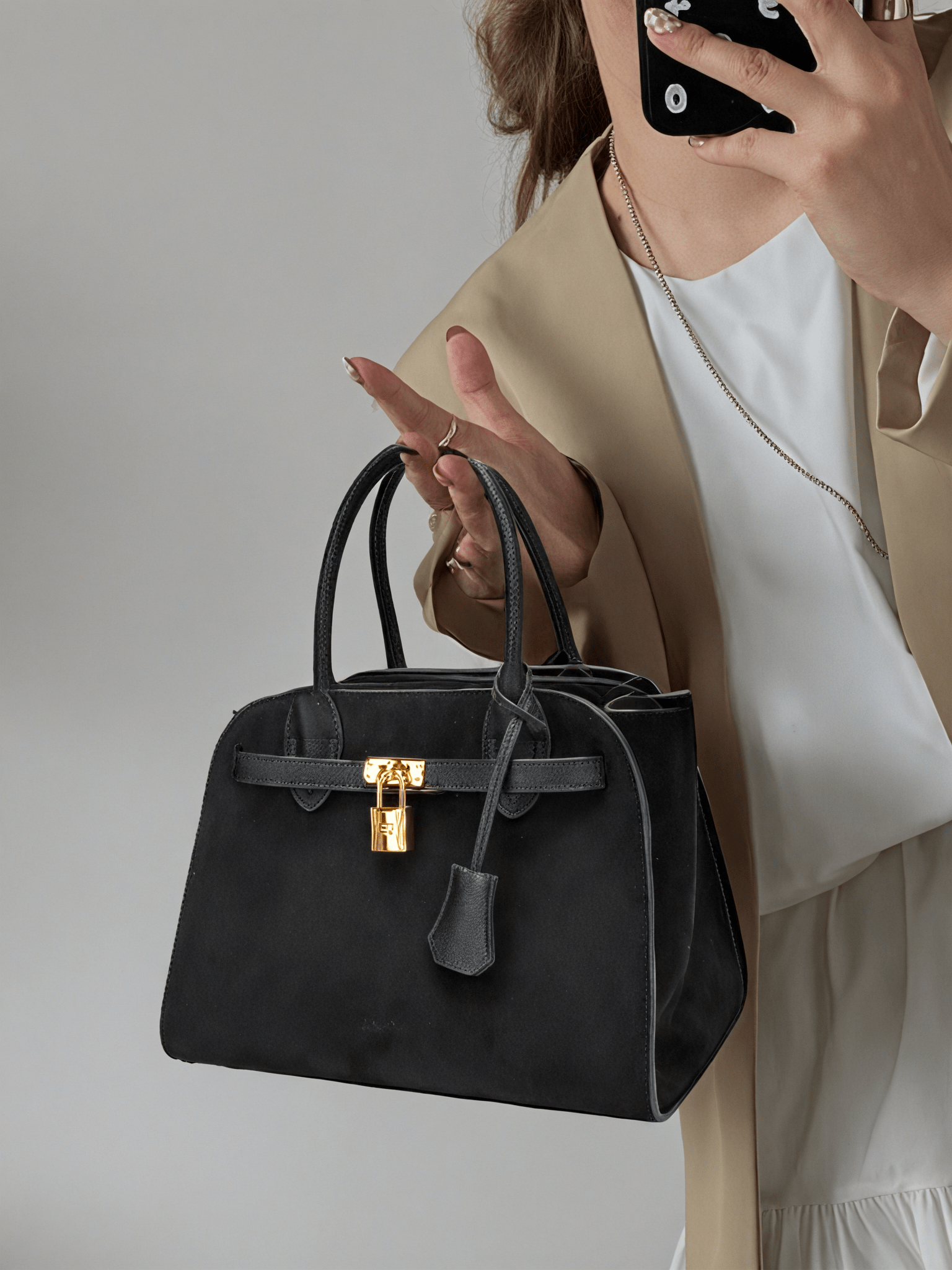 Ramona Top Handle Crossbody Bag in Black Vegan Leather - Model Holding Front View