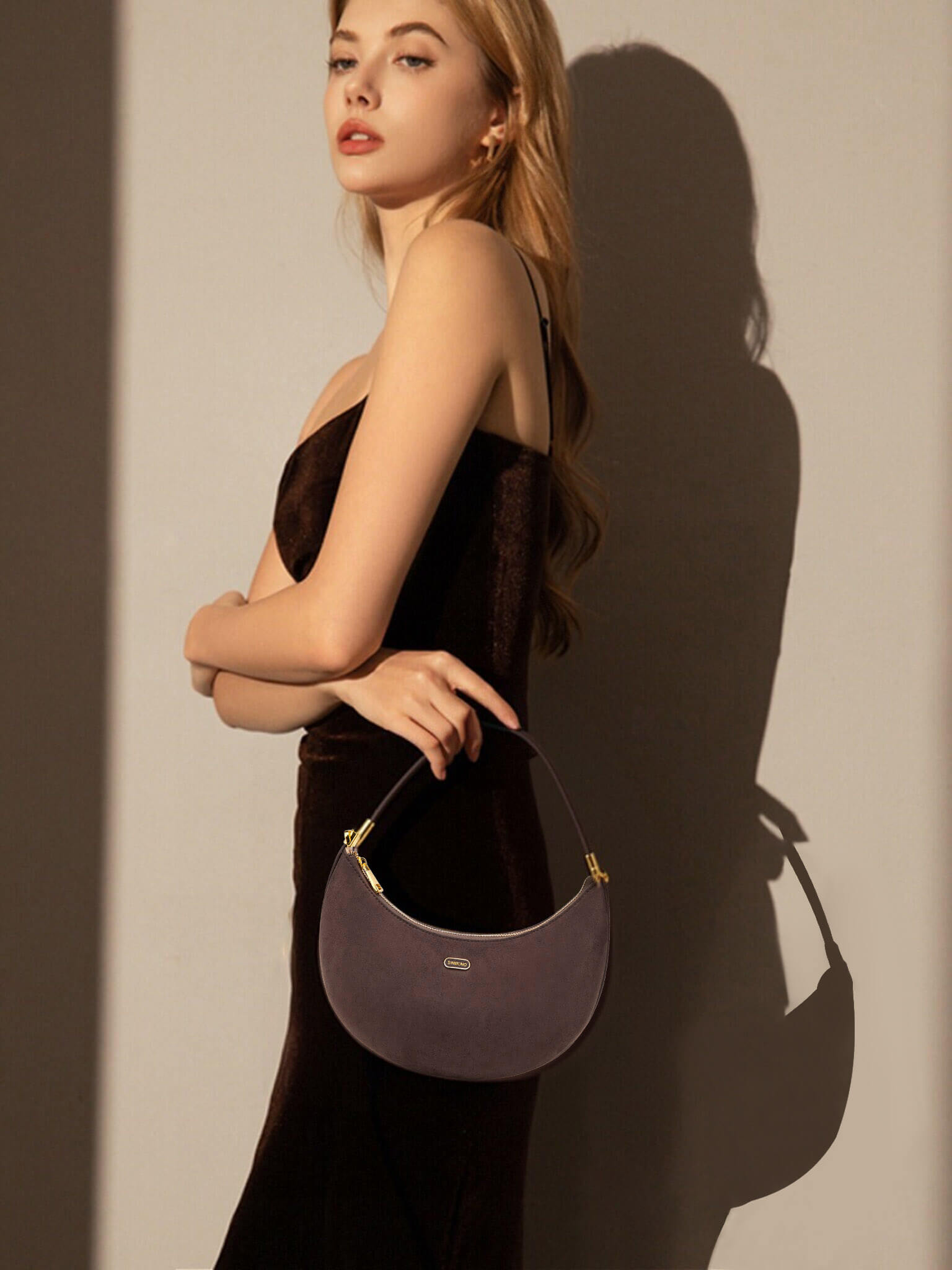 Zoey Shoulder Crossbody Bag  in Dark Brown Fake Suede Denim texture Leather - Model Holding Front View